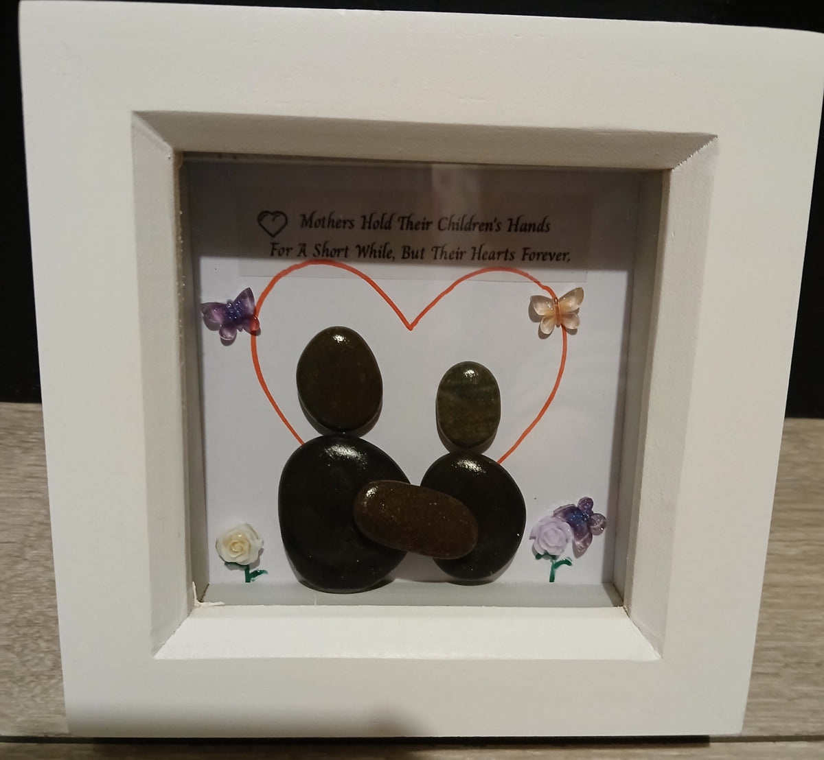 Mothers hold their children's hands for a short while, but their hearts forever. pebble art
