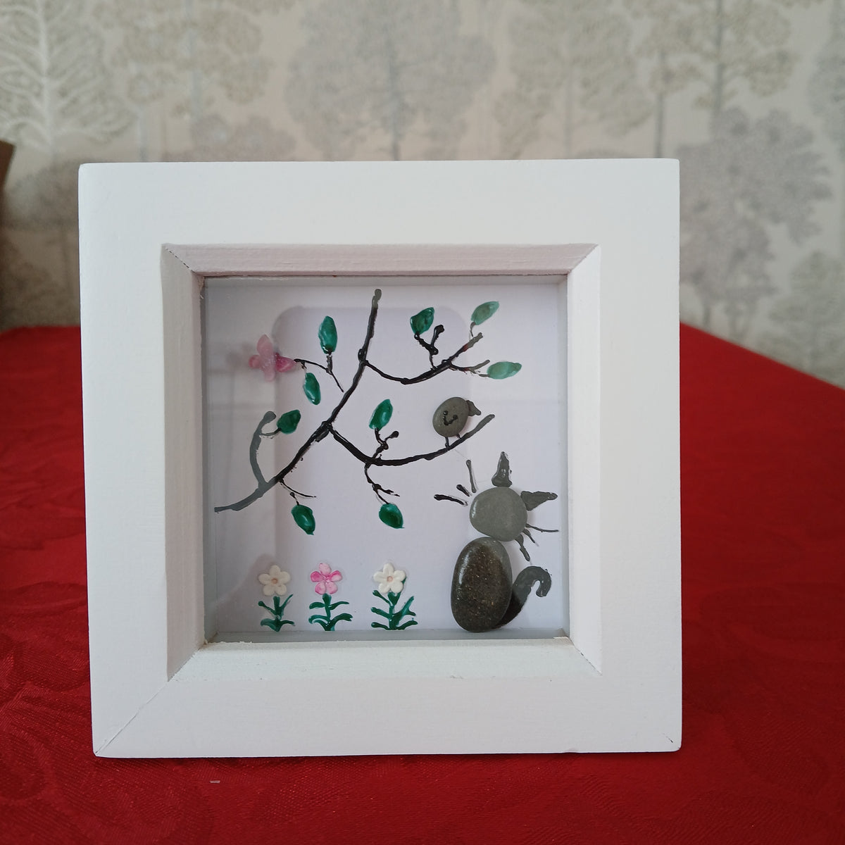 A Cat And Bird in tree pebble art